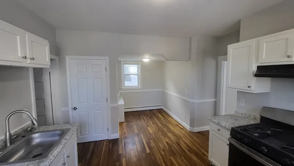 a bathroom with a sink vanity granite toilet tub and shower