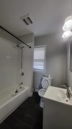 a bathroom with a toilet sink and mirror