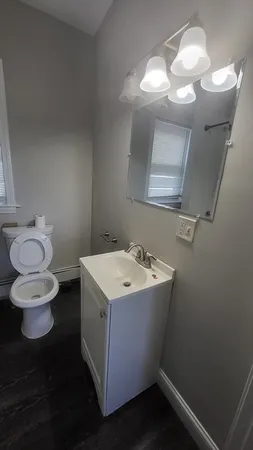 a view of a room with wooden floor and window