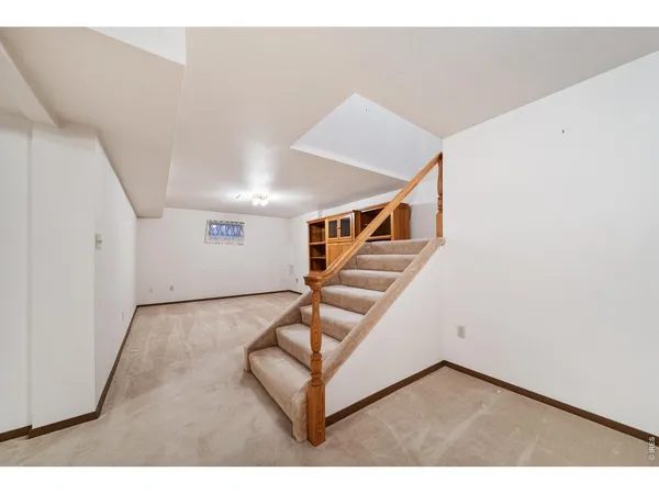 a view of an empty room with stairs