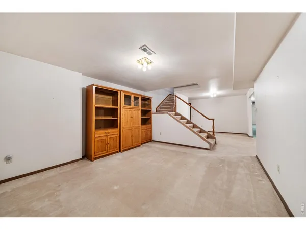 a view of an empty room with a fireplace