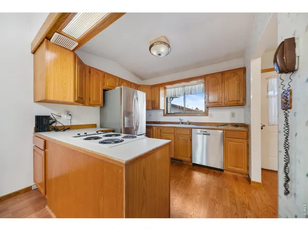 a kitchen with a refrigerator sink and stove