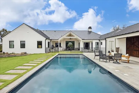 a view of a house with swimming pool and sitting area