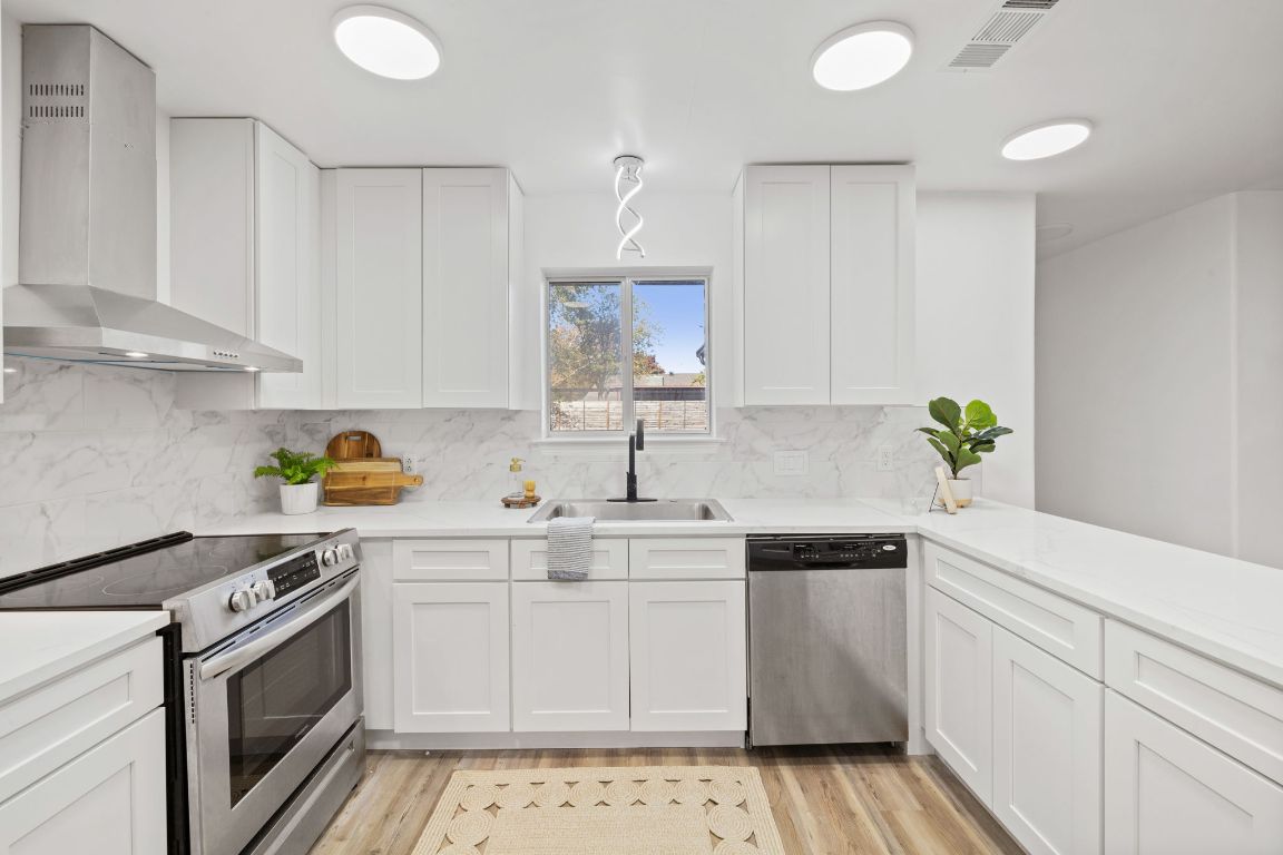 902 Virginia Drive Round Rock, TX 78664 - Photo 12 of 33 a kitchen with a sink stove and cabinets