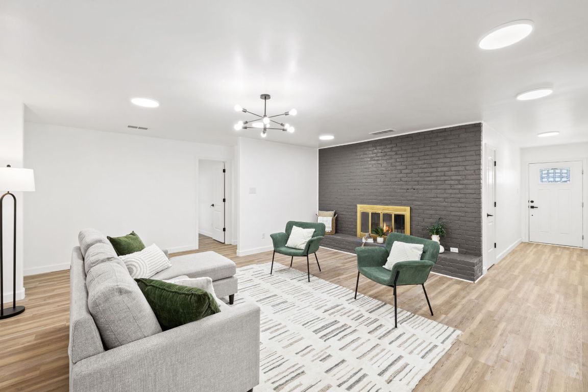902 Virginia Drive Round Rock, TX 78664 - Photo 15 of 33 a living room with furniture and a wooden floor