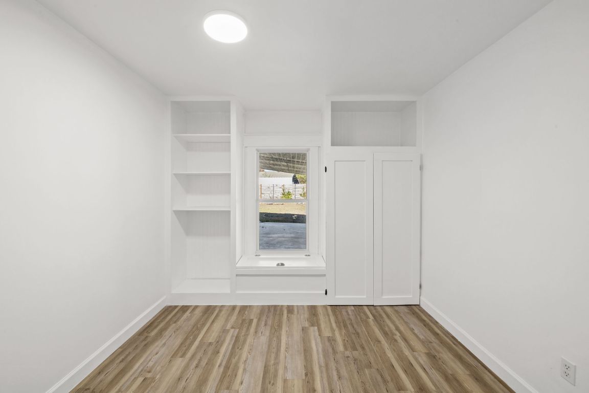 902 Virginia Drive Round Rock, TX 78664 - Photo 16 of 33 wooden floor in an empty room with a window