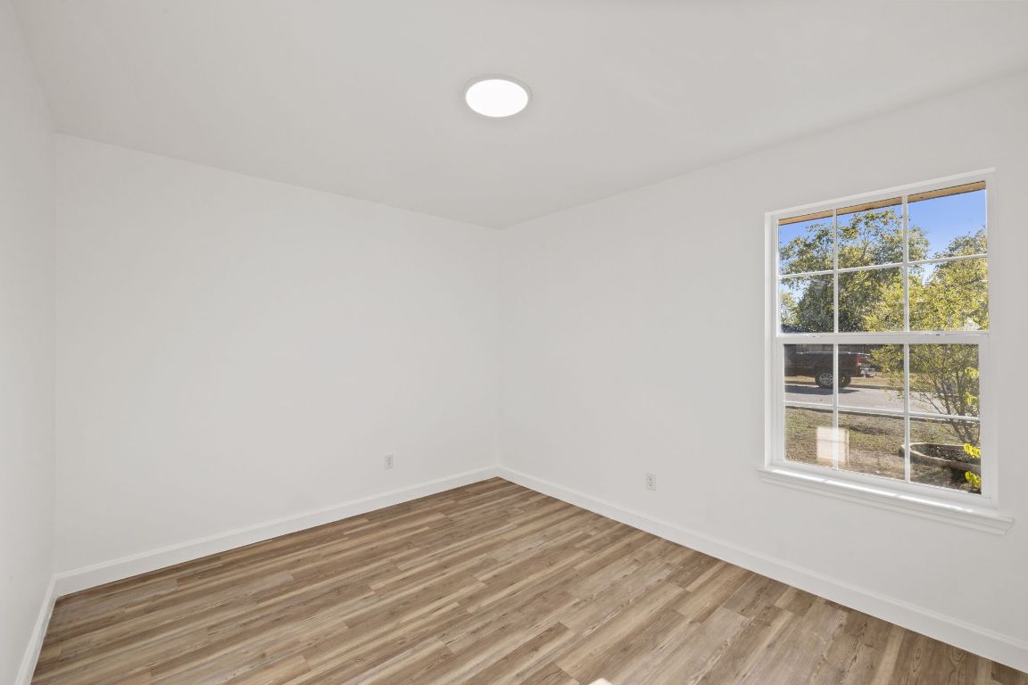 902 Virginia Drive Round Rock, TX 78664 - Photo 23 of 33 a view of empty room with wooden floor and fan