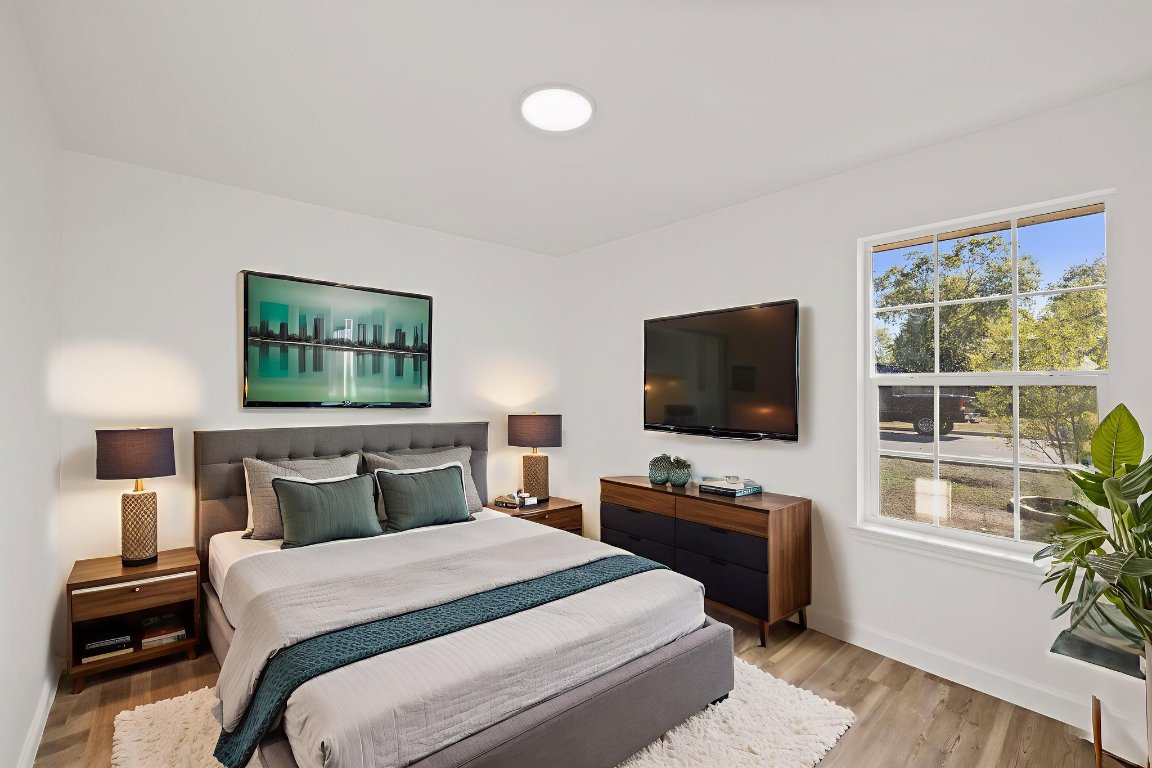902 Virginia Drive Round Rock, TX 78664 - Photo 24 of 33 a bedroom with a bed and a flat screen tv