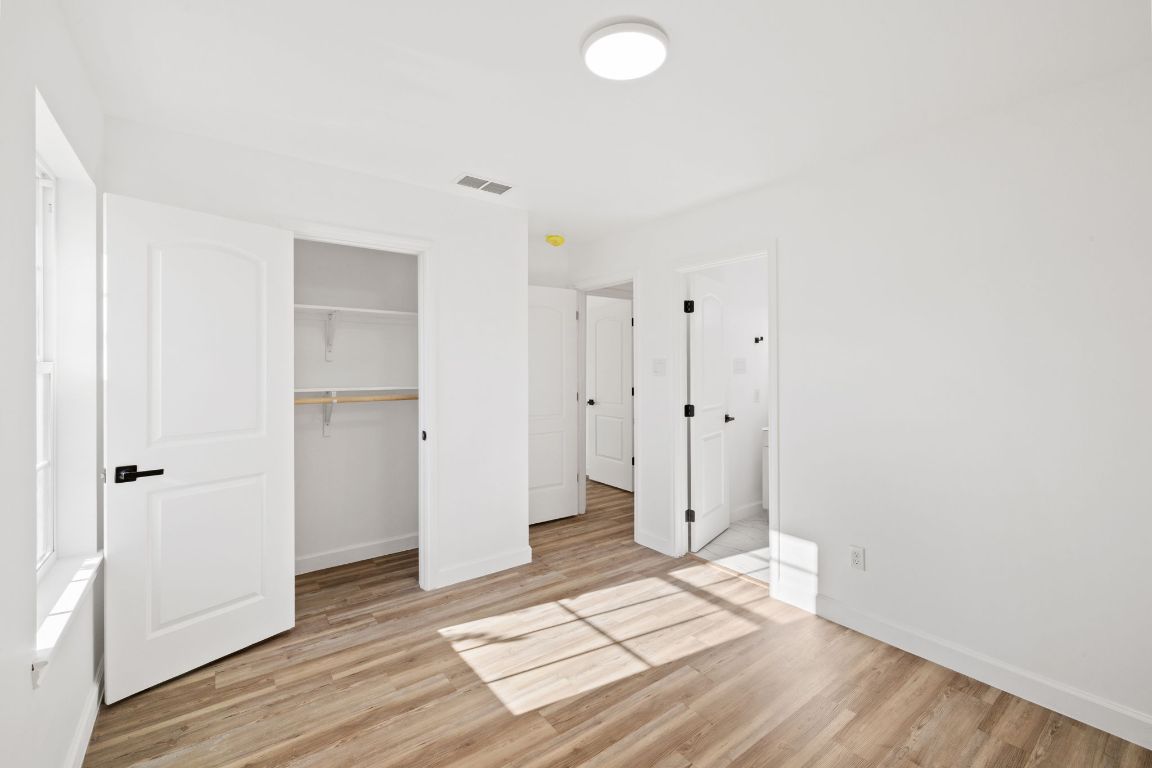 902 Virginia Drive Round Rock, TX 78664 - Photo 25 of 33 a view of an empty room with wooden floor