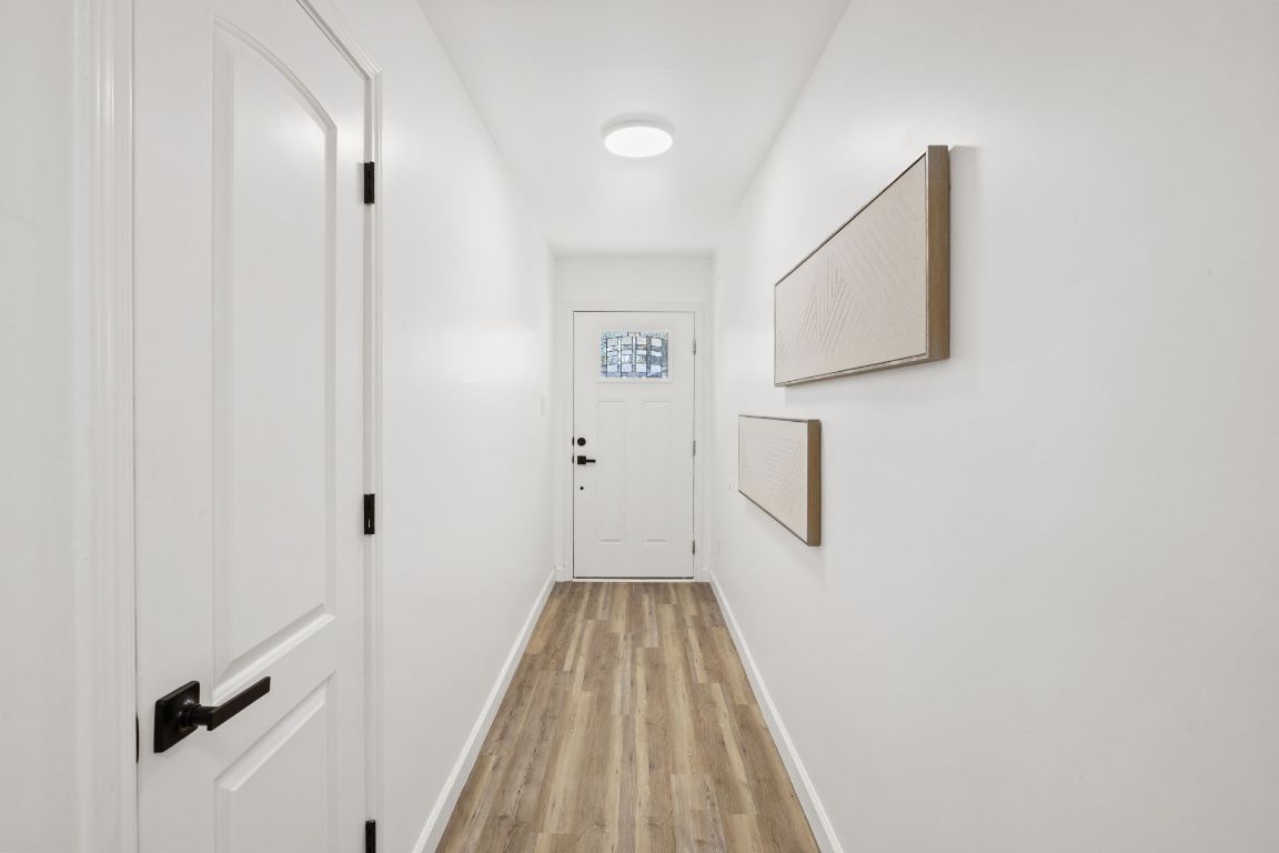 902 Virginia Drive Round Rock, TX 78664 - Photo 5 of 33 a view of a hallway with wooden floor and entryway