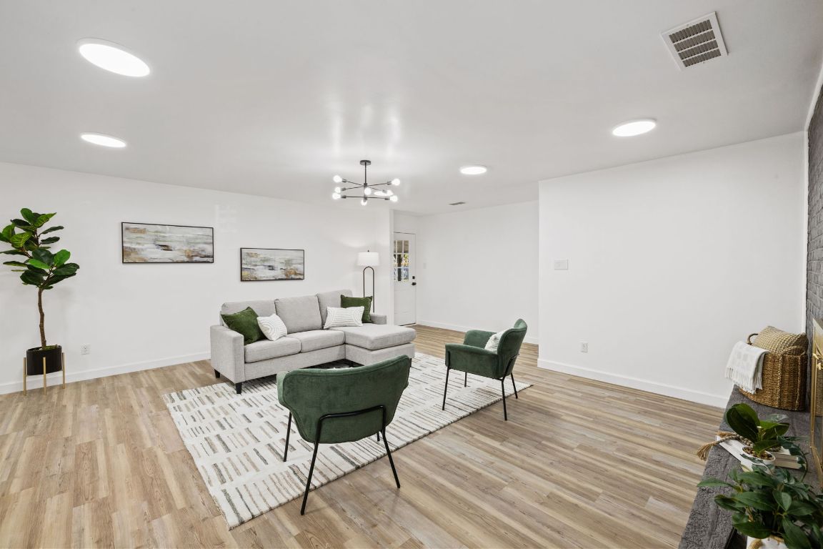 902 Virginia Drive Round Rock, TX 78664 - Photo 6 of 33 a living room with furniture and a wooden floor