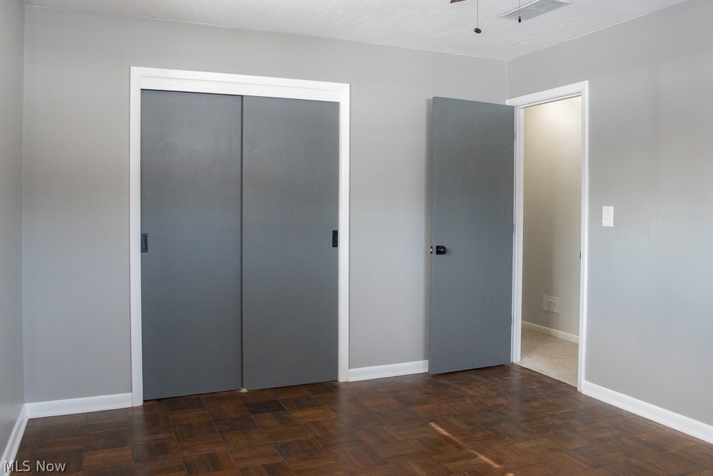 100 Orton Road Painesville, OH 44077 - Photo 28 of 35 Freshly Painted Bedroom with Refinished Wood Parquet Floors and Ceiling Fan