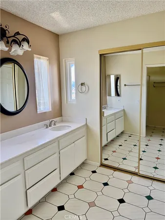 a bathroom with a sink a toilet and mirror