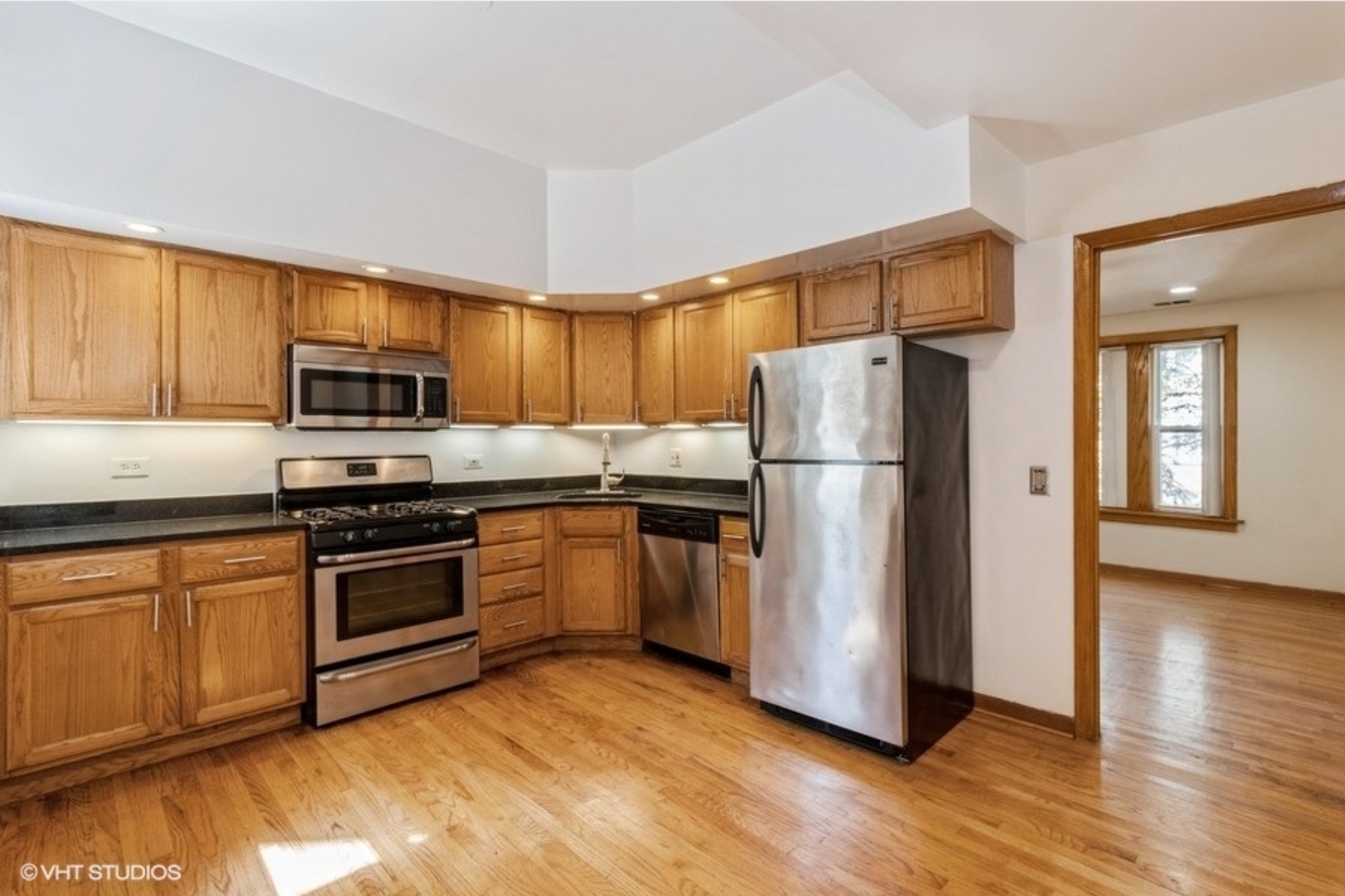 Undisclosed Address Chicago, IL 60647 - Photo 2 of 15 a kitchen with a refrigerator stove and wooden cabinets