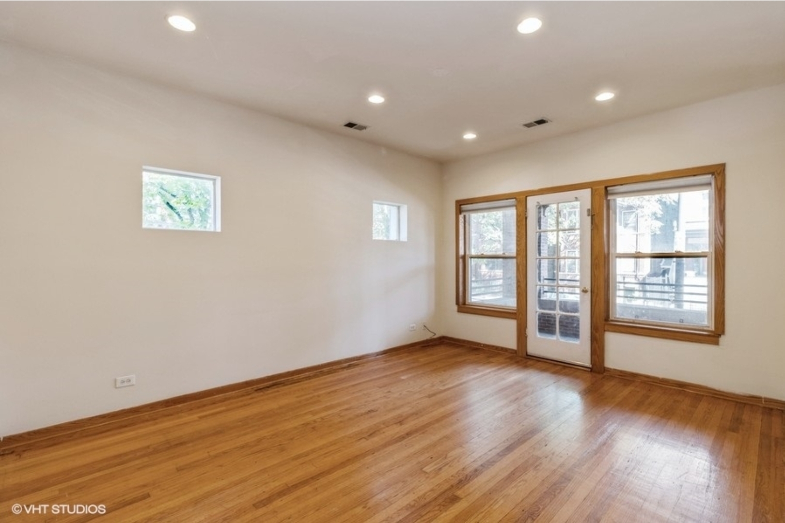 Undisclosed Address Chicago, IL 60647 - Photo 4 of 15 a view of an empty room with wooden floor and a window