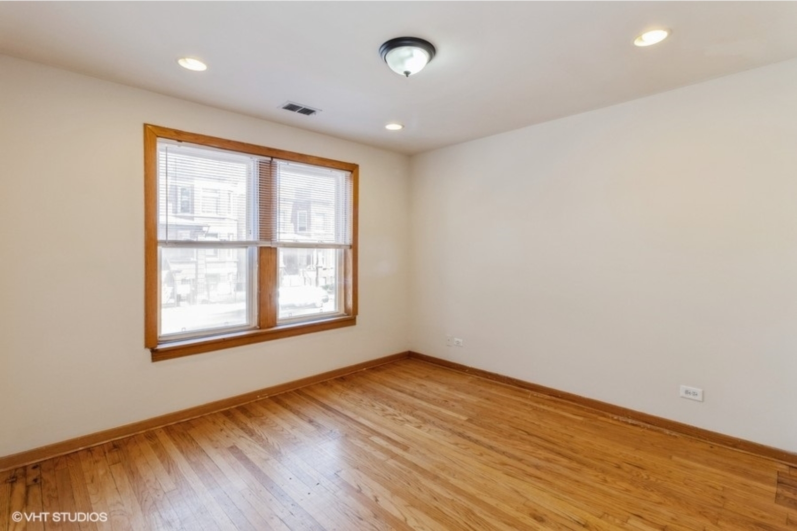 Undisclosed Address Chicago, IL 60647 - Photo 7 of 15 a view of an empty room with wooden floor and a window