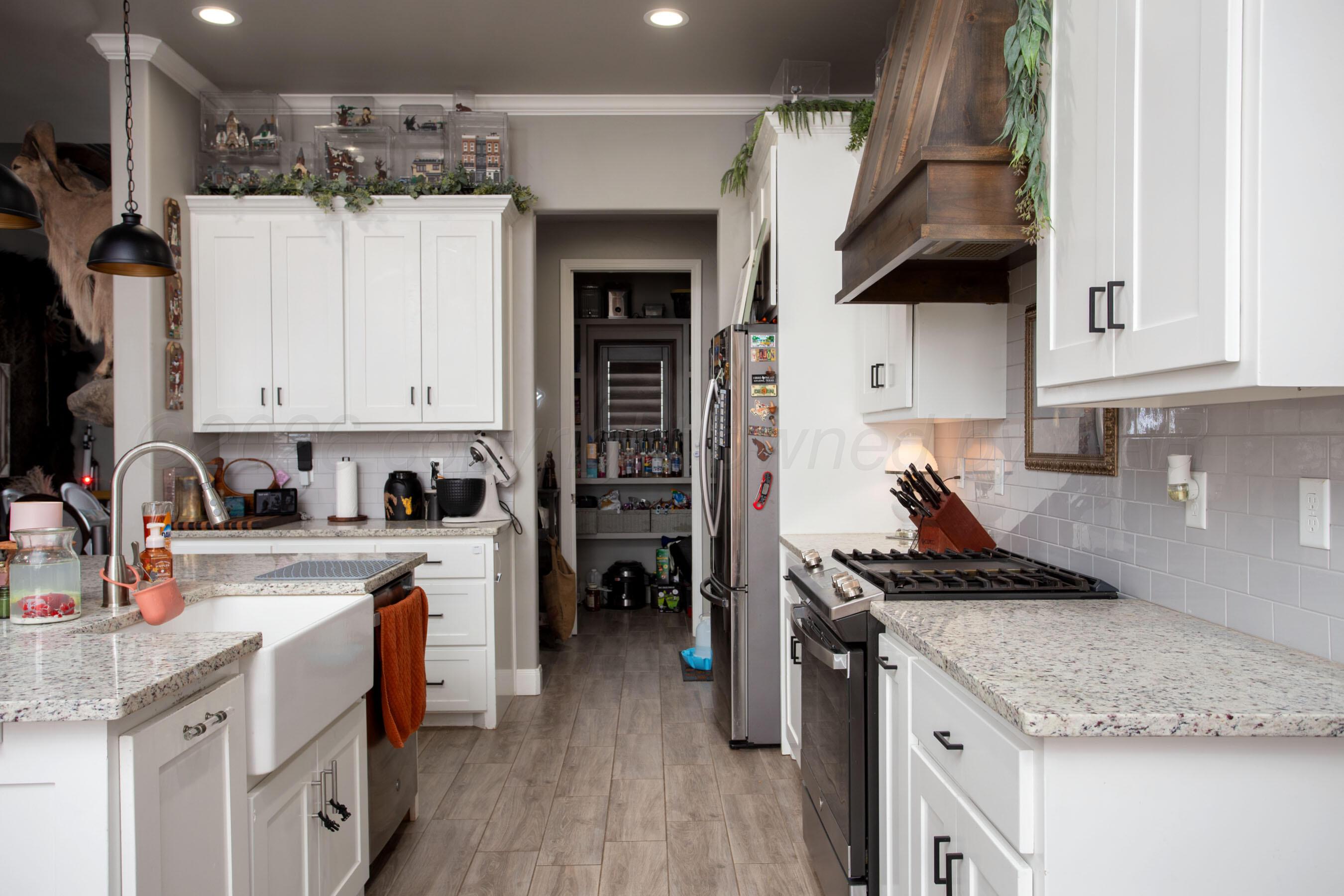 8200 Matilda Lane Amarillo, TX 79119 - Photo 11 of 39 a kitchen with a stove a sink and a refrigerator