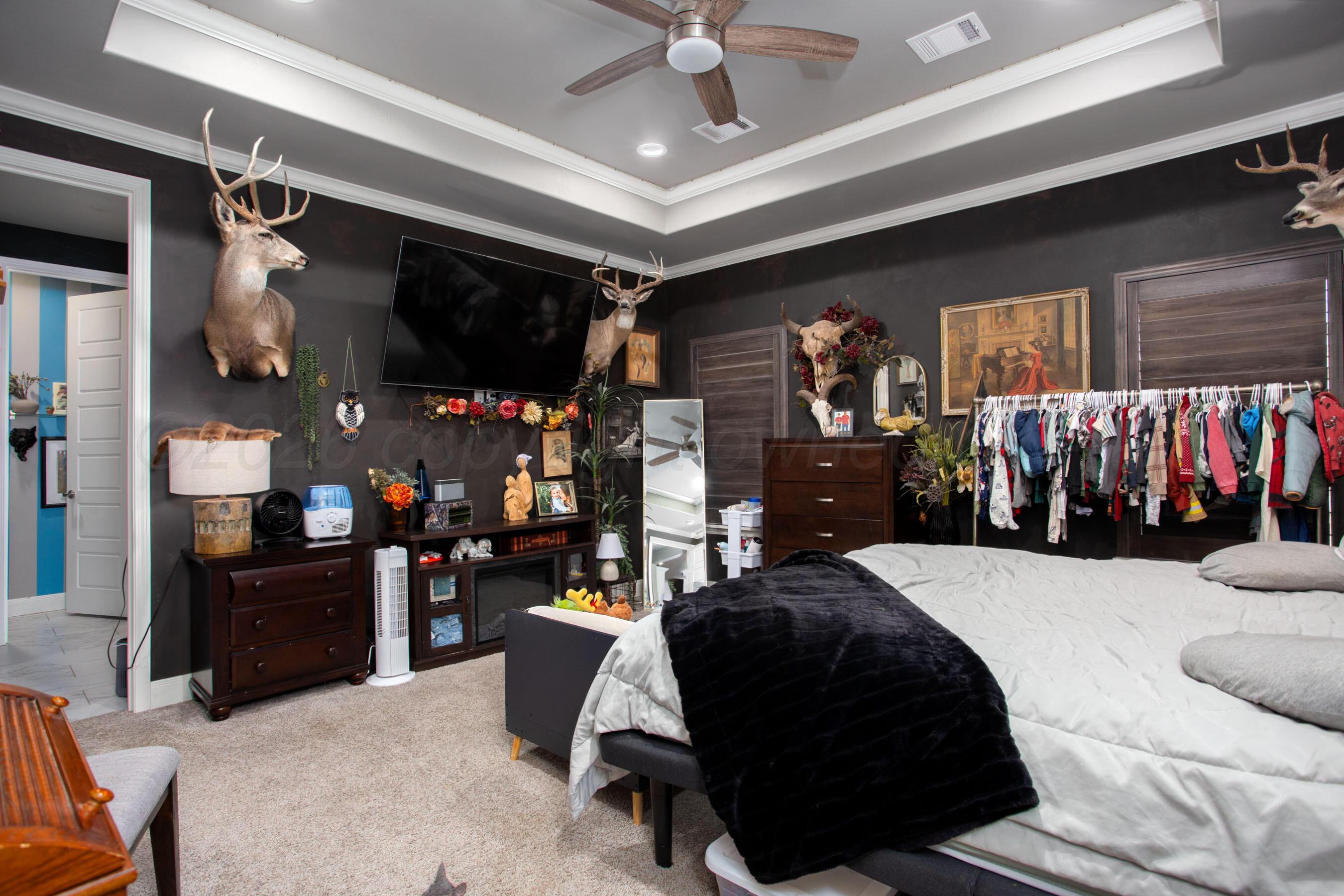 8200 Matilda Lane Amarillo, TX 79119 - Photo 15 of 39 a bedroom with a bed a mirror and a walk in closet