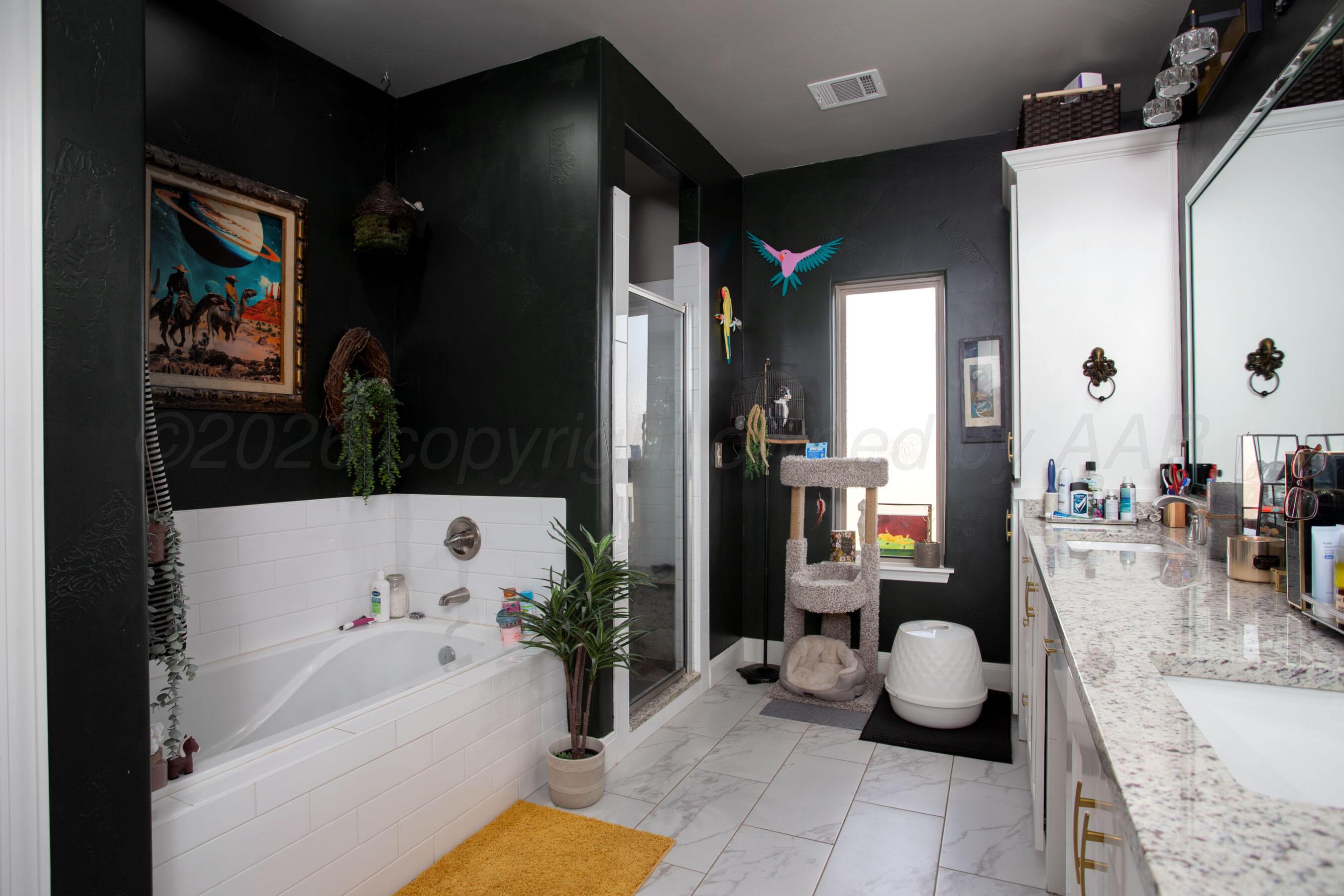 8200 Matilda Lane Amarillo, TX 79119 - Photo 17 of 39 a bathroom with a tub shower and sink or mirror