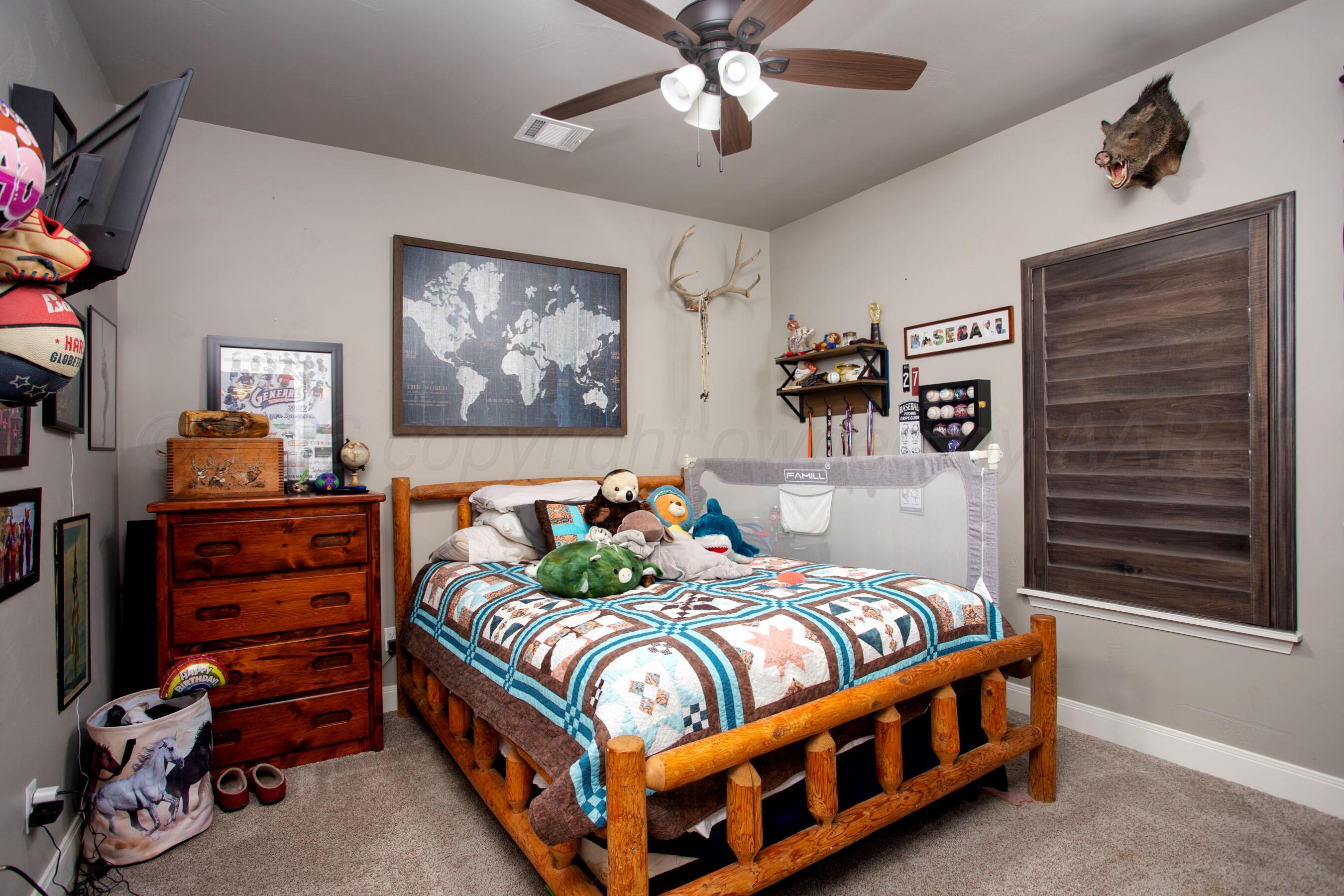 8200 Matilda Lane Amarillo, TX 79119 - Photo 24 of 39 a bedroom with bed and paintings on the wall