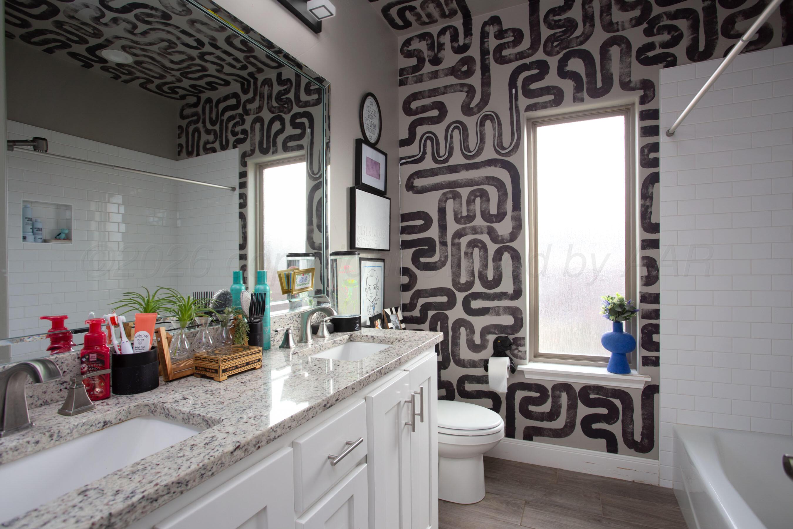 8200 Matilda Lane Amarillo, TX 79119 - Photo 26 of 39 a bathroom with a granite countertop sink and a mirror