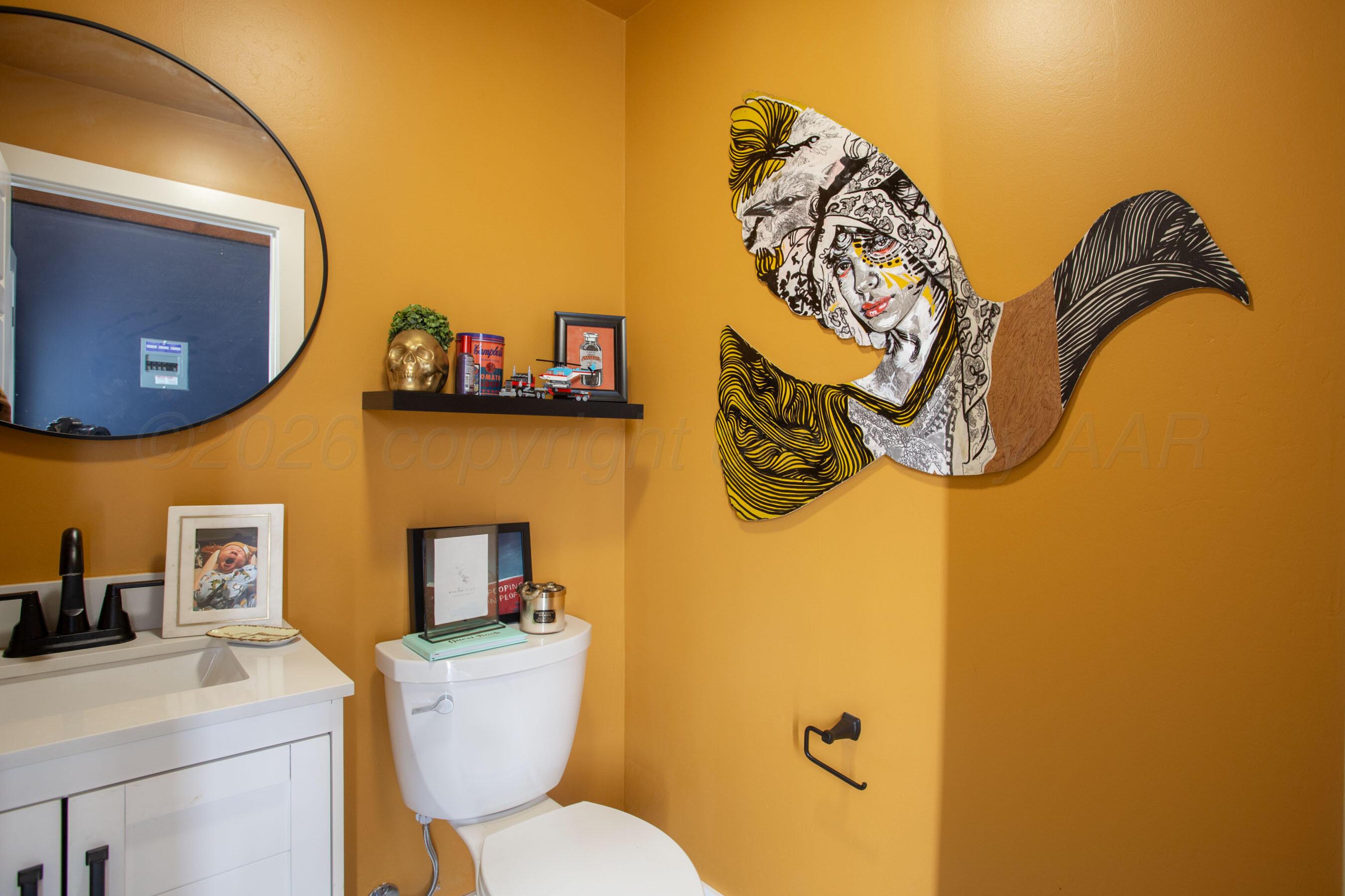 8200 Matilda Lane Amarillo, TX 79119 - Photo 30 of 39 a bathroom with a toilet sink and mirror