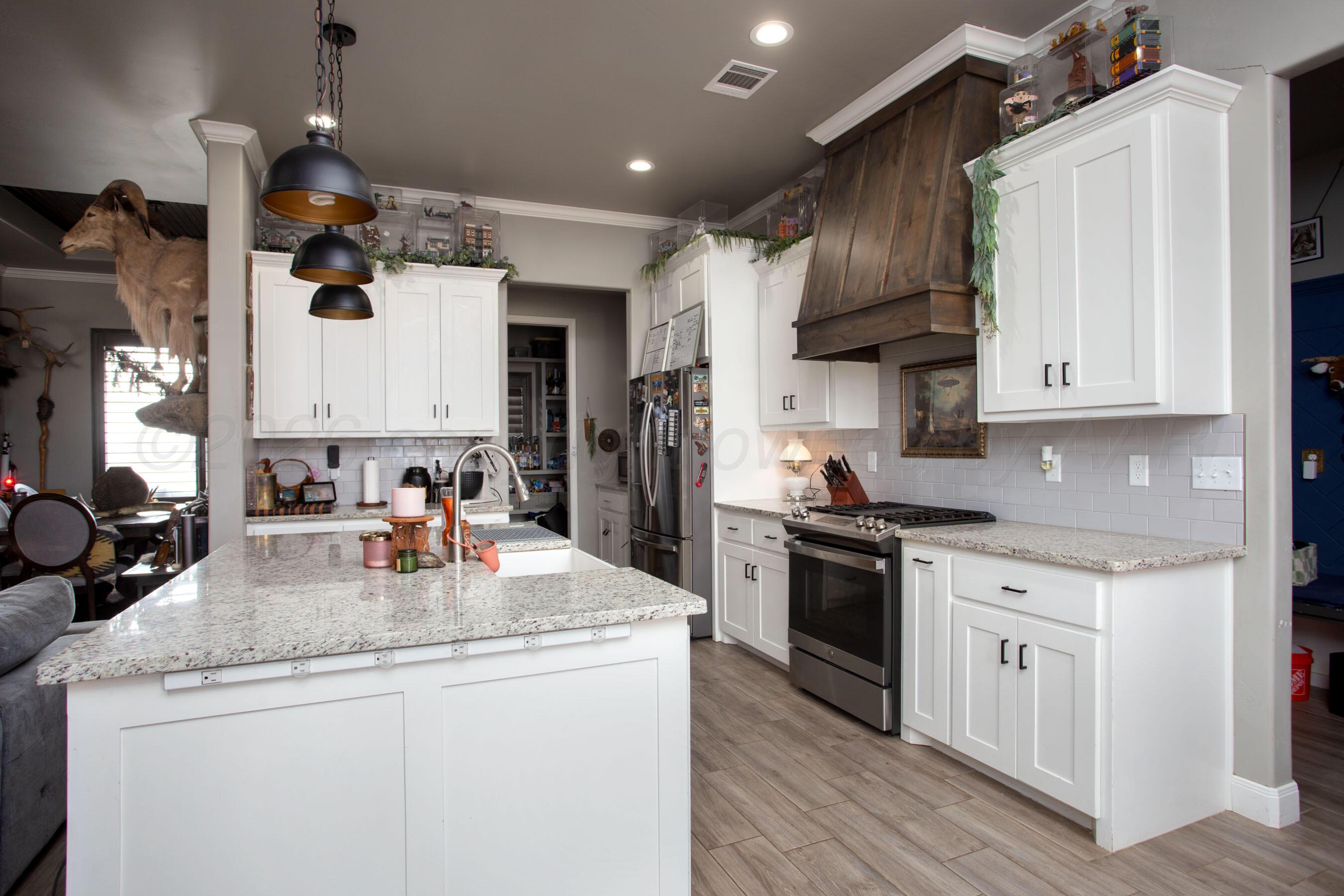 8200 Matilda Lane Amarillo, TX 79119 - Photo 9 of 39 a kitchen with stainless steel appliances granite countertop a sink a stove and a refrigerator