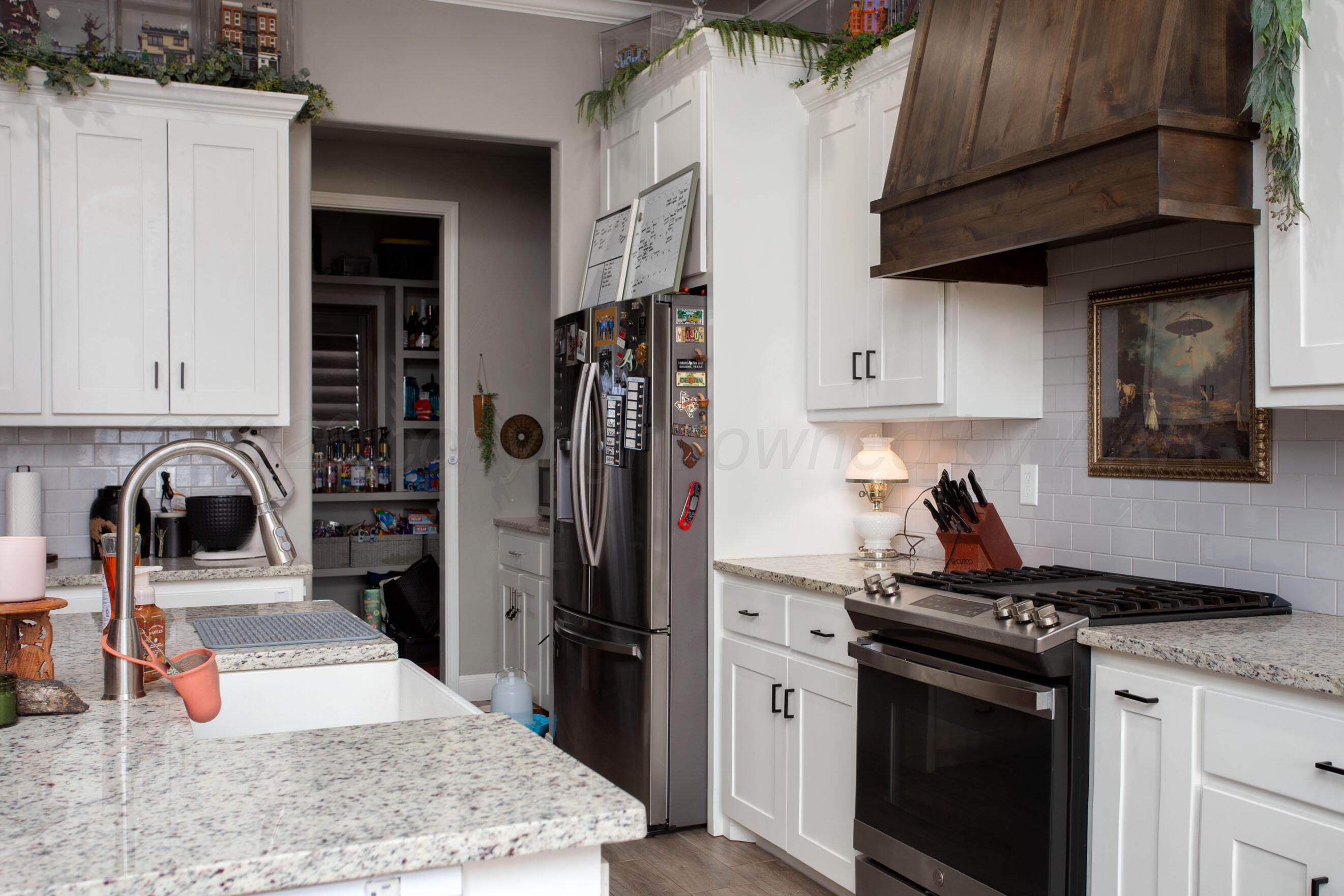 8200 Matilda Lane Amarillo, TX 79119 - Photo 10 of 39 a kitchen with stainless steel appliances granite countertop a refrigerator stove and sink