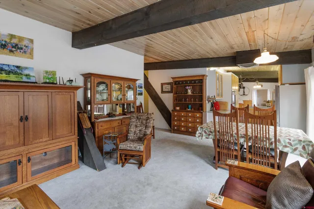 a view of a livingroom with furniture and staircase