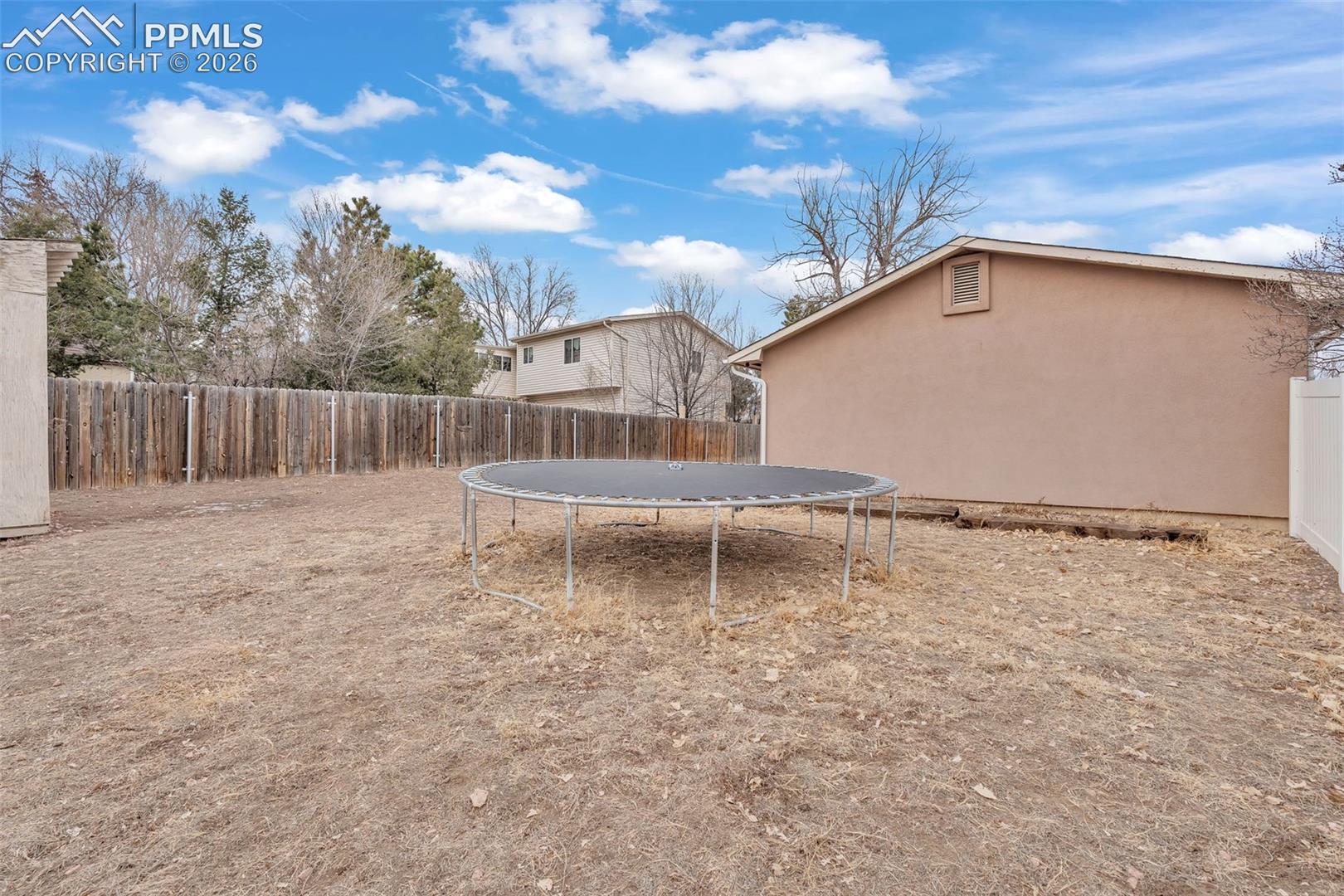 1498 Peterson Road Colorado Springs, CO 80915 - Photo 37 of 44 Fenced backyard featuring a trampoline