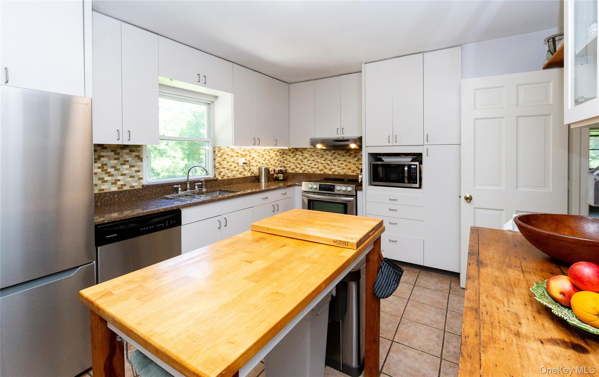 32 Cobb Road Brewster, NY 10509 - Photo 19 of 49 a kitchen with stainless steel appliances granite countertop a sink a stove and refrigerator