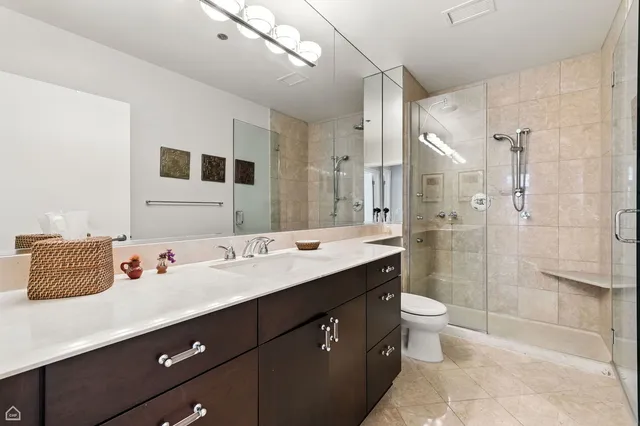 a bathroom with a sink a toilet and shower
