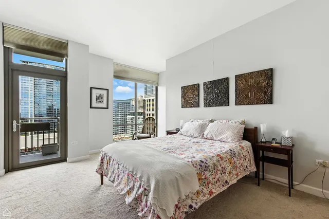 a bedroom with a bed wooden floor and window