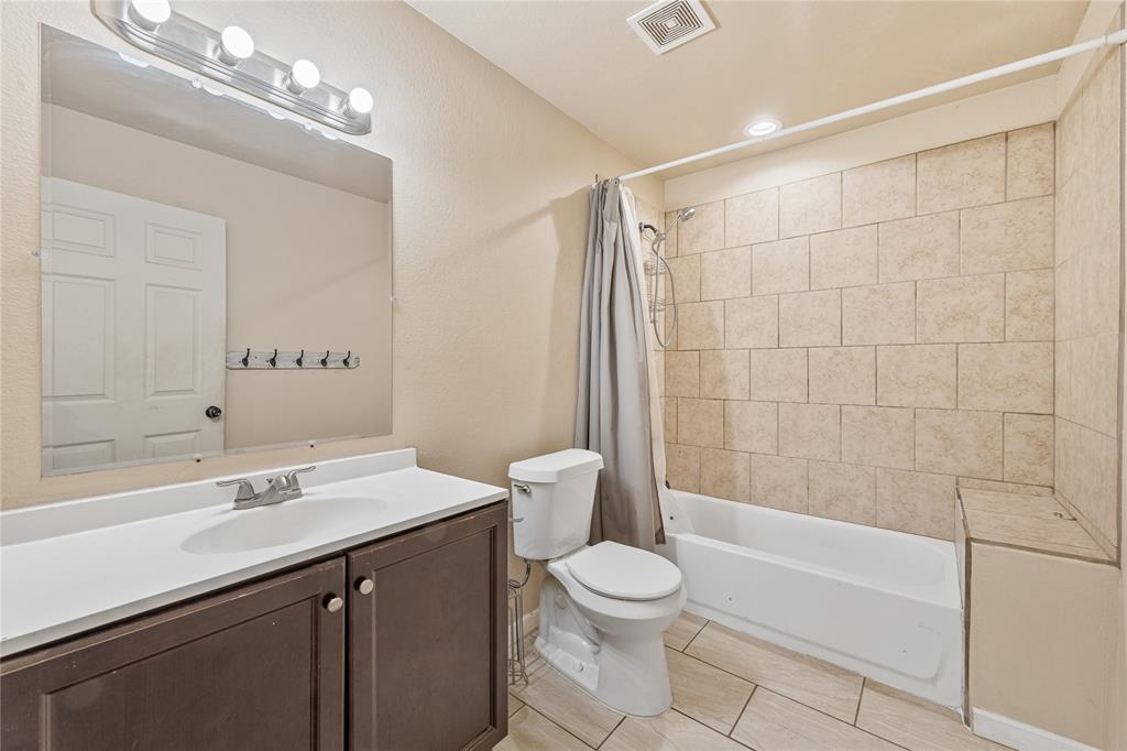 409 Morgan Mill Road Stephenville, TX 76401 - Photo 15 of 25 a bathroom with a sink a toilet and shower
