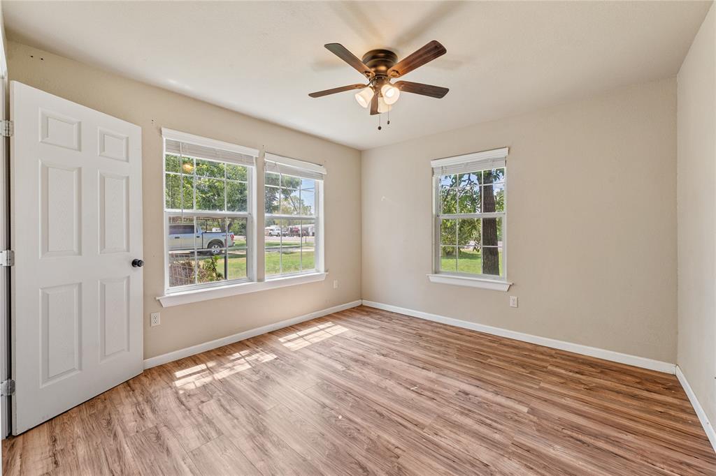 409 Morgan Mill Road Stephenville, TX 76401 - Photo 18 of 25 wooden floor in an empty room with a window