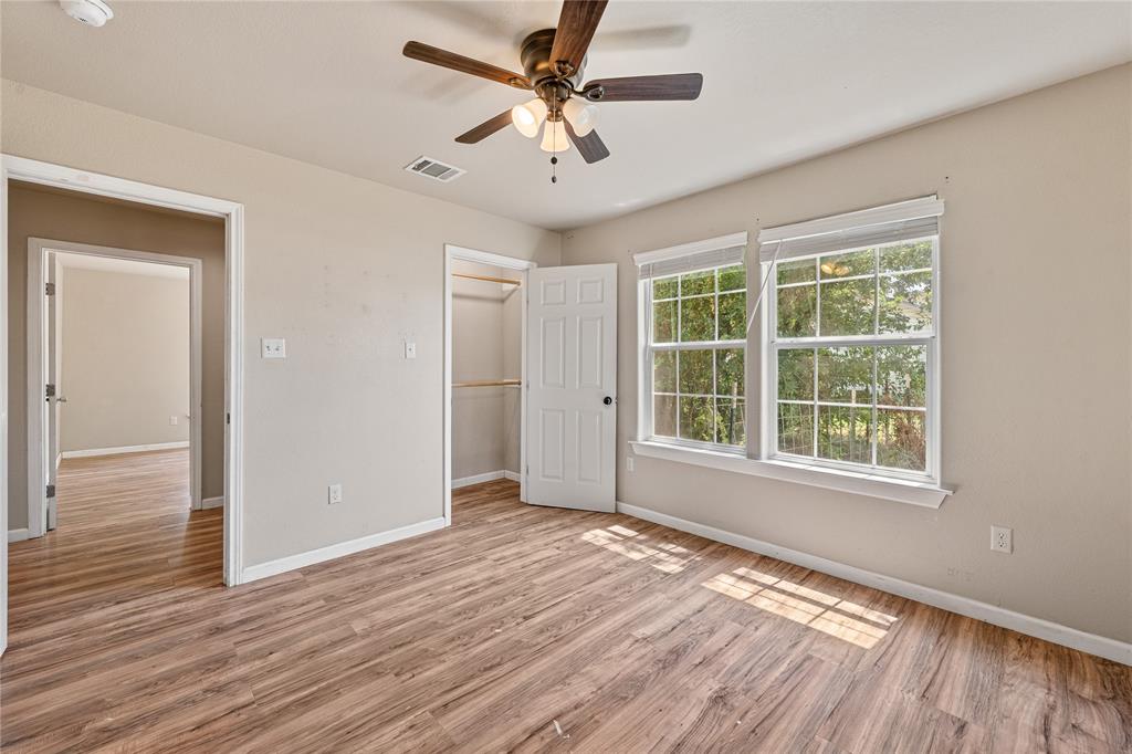 409 Morgan Mill Road Stephenville, TX 76401 - Photo 19 of 25 a view of an empty room with wooden floor and a window
