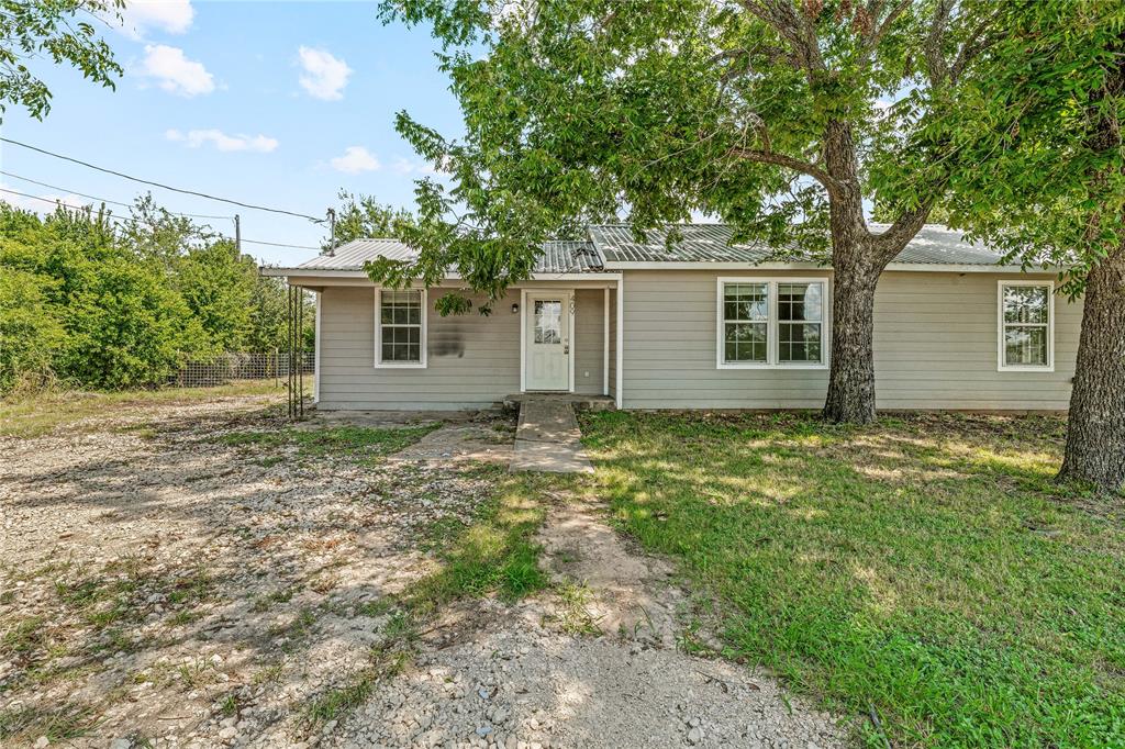 409 Morgan Mill Road Stephenville, TX 76401 - Photo 2 of 25 front view of house with a yard