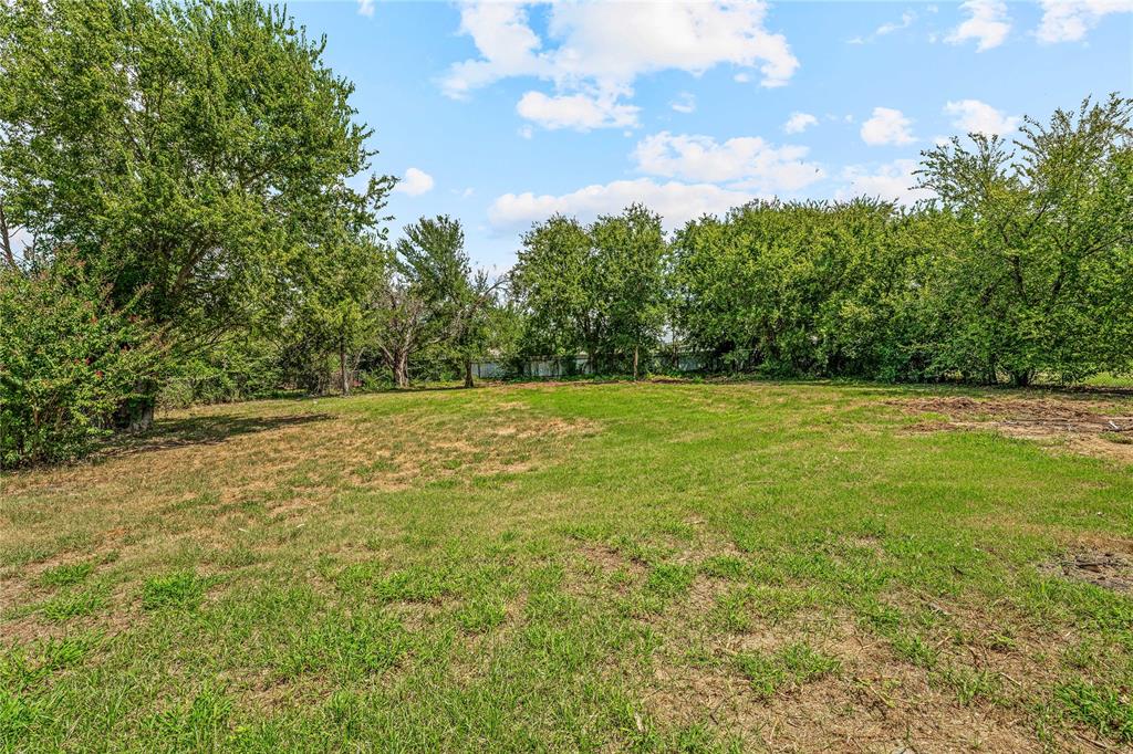 409 Morgan Mill Road Stephenville, TX 76401 - Photo 21 of 25 a view of a field with an trees in the background
