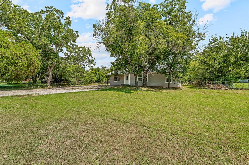 409 Morgan Mill Road Stephenville, TX 76401 - Photo 4 of 25 a view of outdoor space with deck and trees