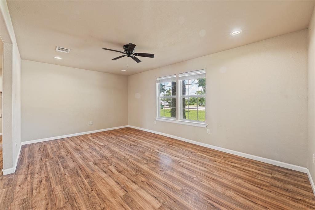 409 Morgan Mill Road Stephenville, TX 76401 - Photo 5 of 25 a view of empty room with wooden floor and fan