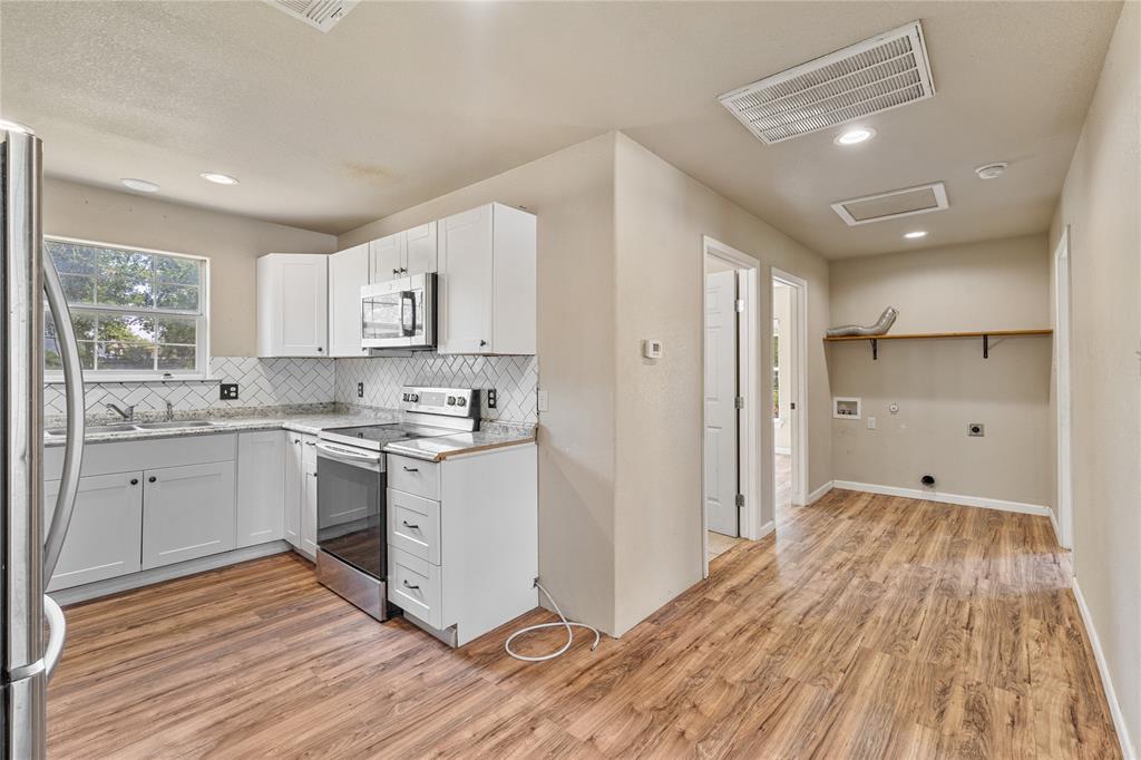 409 Morgan Mill Road Stephenville, TX 76401 - Photo 9 of 25 a view of a kitchen with wooden floor