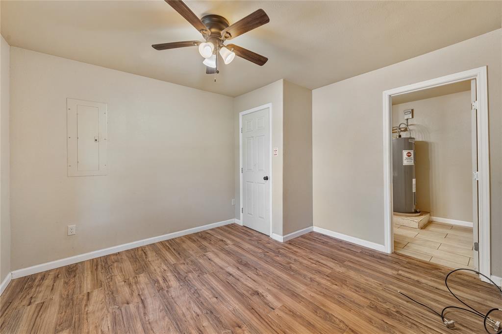 409 Morgan Mill Road Stephenville, TX 76401 - Photo 10 of 25 wooden floor in an empty room with a window