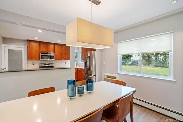 a kitchen with stainless steel appliances a sink a stove top oven a counter space and cabinets