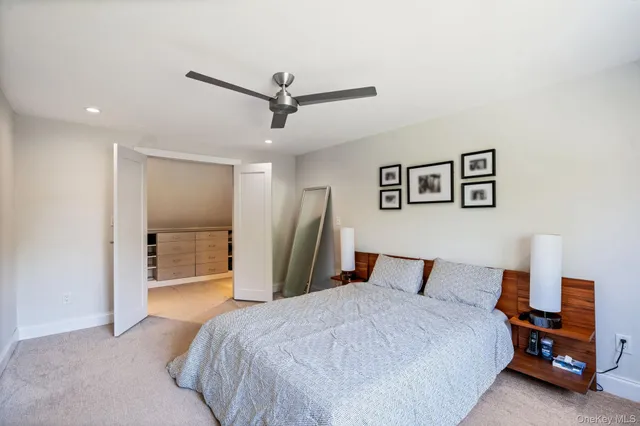 a bedroom with a large bed and a chandelier