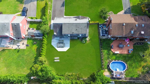 an aerial view of a house with a swimming pool yard and outdoor seating