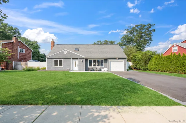a view of a house with a big yard plants and large trees