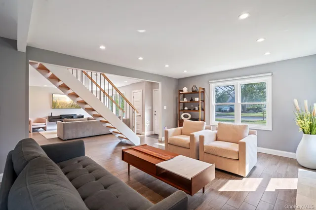 a living room with furniture and a potted plant