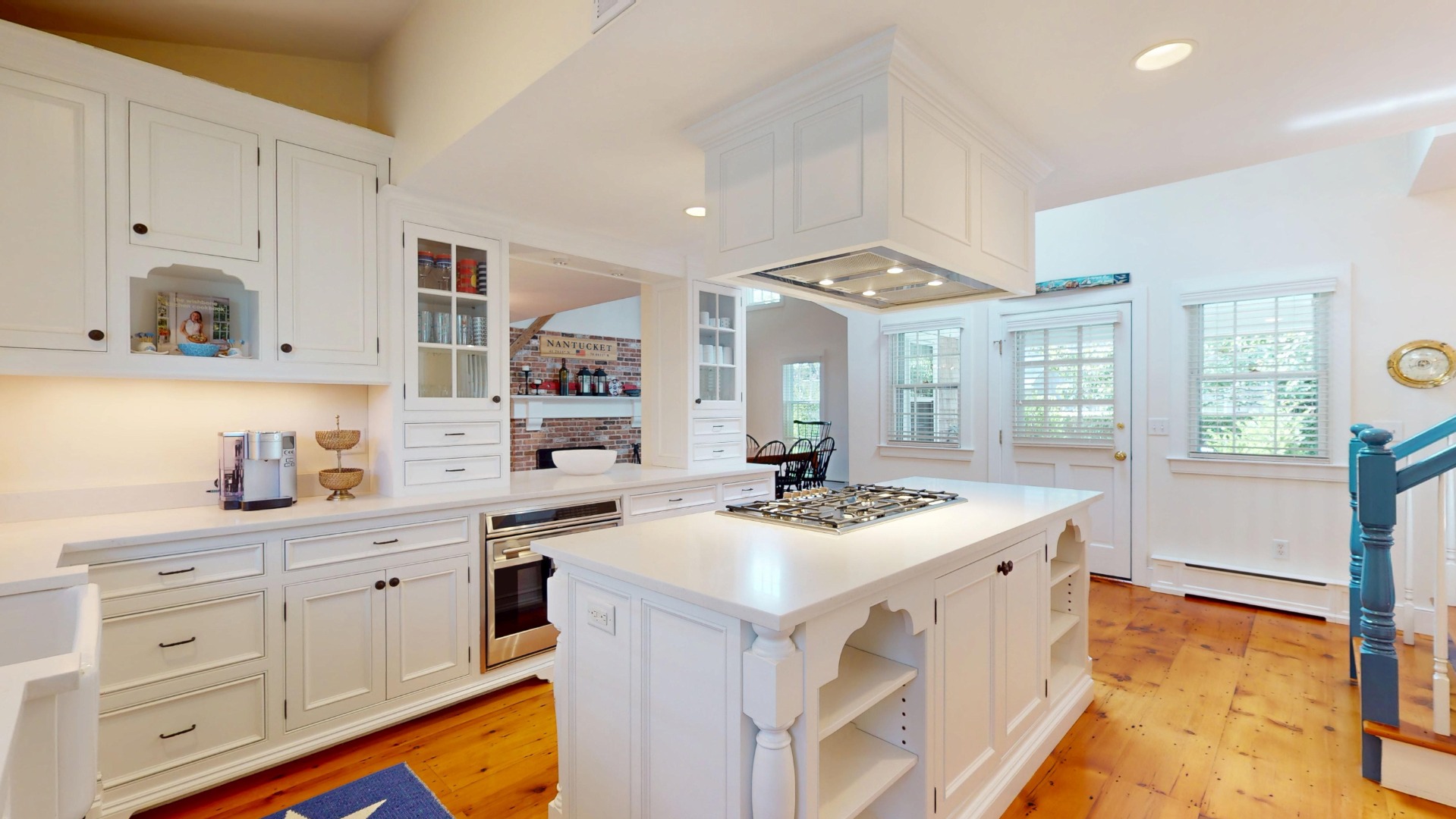 39 A Milk Street Nantucket, MA 02554 - Photo 13 of 56 a kitchen that has a lot of cabinets in it and wooden floors