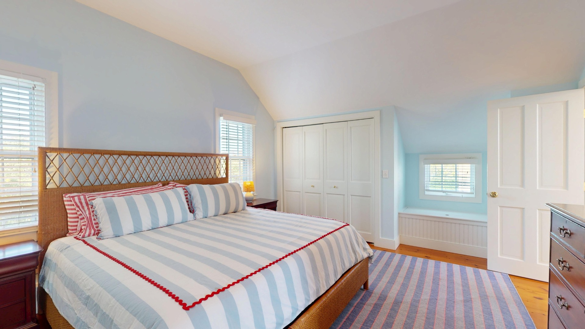 39 A Milk Street Nantucket, MA 02554 - Photo 34 of 56 a bedroom with a bed and wooden floor