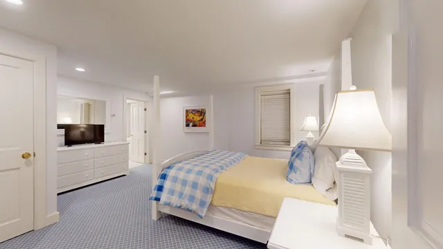 a view of a patio with table and chairs under an umbrella